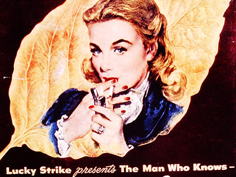 An old advertisement for Lucky Strike in which a blonde woman lights a cigarette.