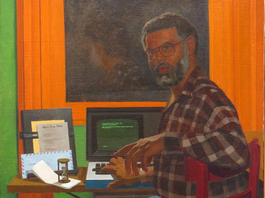 Portrait of Samuel Delany at his desk turning to look over his shoulder