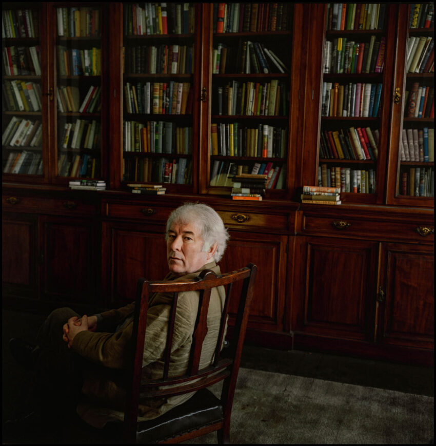 Seamus Heaney surrounded by books
