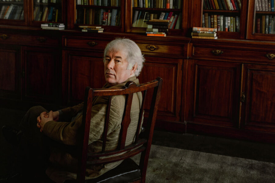 Seamus Heaney surrounded by books at London’s Royal Society of Literature in March 1995