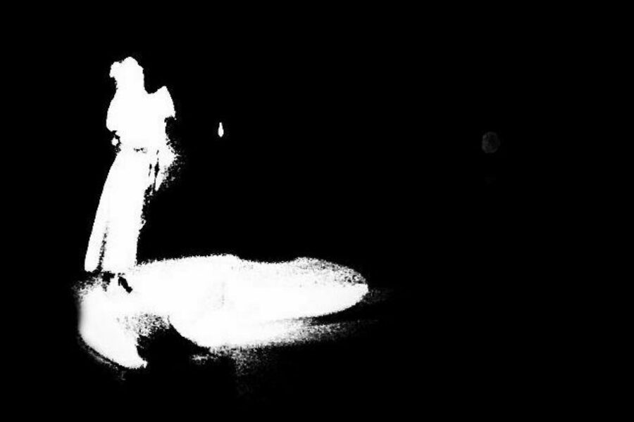 Shadowy white figure on a black ground. Detail from Jose Chavvary / Creative Commons.