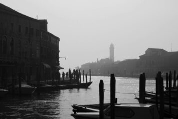 Black-and-white photo of an empty canal on the island of Murano in Venice, Italy