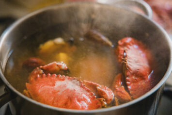 Crabs cooking in a pot of steaming water