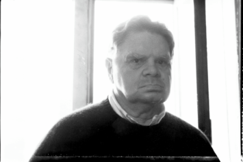 Black-and-white photo of James Schuyler in the hallway of the Chelsea Hotel, New York City, 1988