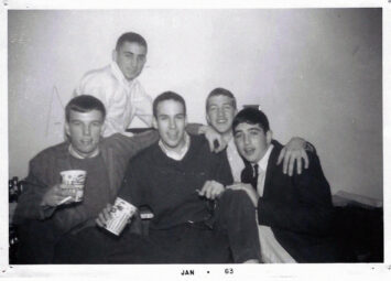 Black-and-white yearbook photo showing David Lynch and Bill Frazier sitting with a group of friends at a fraternity party.