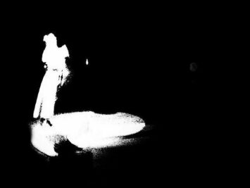 Shadowy white figure on a black ground. Detail from Jose Chavvary / Creative Commons.