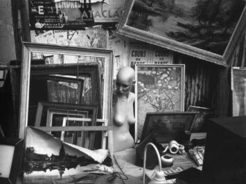 black and white photo of picture frames and scattered sculptural items