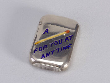 photograph of metal match box with "a [image of a match] for you at any time" printed on the front