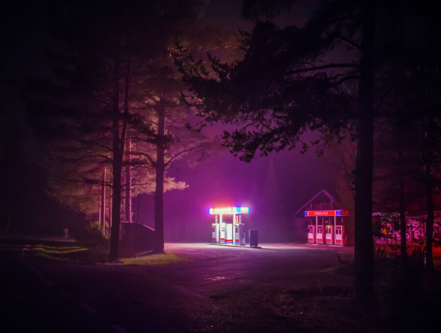 Maria Lax gas station amid trees photo